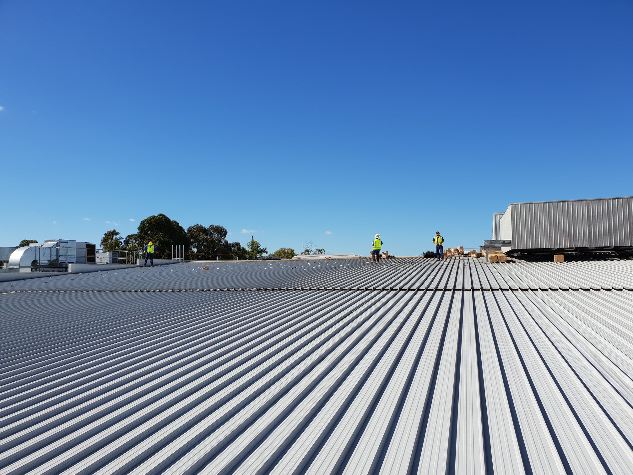 Workers on Roof — Electricians in St Inverell, NSW